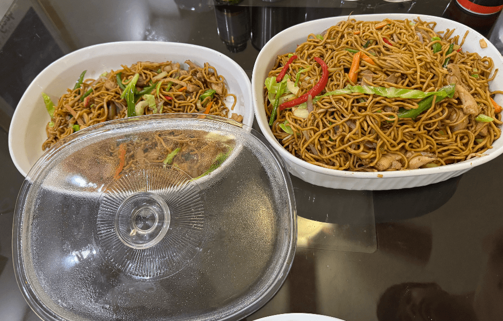 Two dishes of chow mein made by Jose